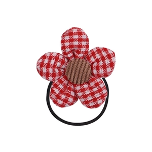 Close-up of cute floral hair tie with red and white checkered petals and brown center