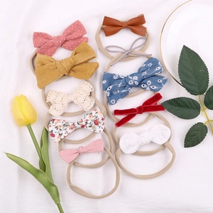 Set of 10 cute nylon baby headbands with various fabric bows for infants and toddlers