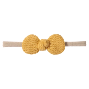 Close-up of ginger waffle fabric bow and high-elastic nylon band for infant headband