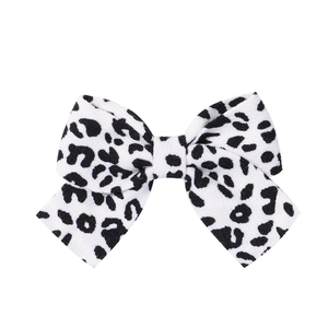 Detailed view of the woven fabric texture and leopard print pattern on the bow hair clip