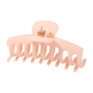 Detail view of large matte peach hair claw clip with strong metal spring for thick hair