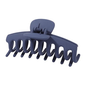 Detail of matte dark blue hair claw clip with strong metal spring and multi-tooth grip