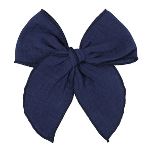 Close-up of a large dark blue linen bow hair clip with detailed edge stitching textures