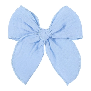 Detailed close-up of light blue fabric bow clip showing soft texture and fine stitching