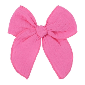 Detailed texture of a large fuchsia pink cotton fabric bow hair clip accessory
