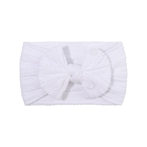 Detail showing soft white ribbed nylon headband for baby with large decorative bow