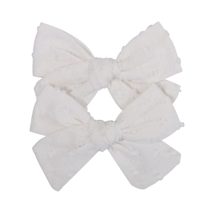 Pair of white Swiss dot cotton hair bows for girls with delicate textured fabric detail