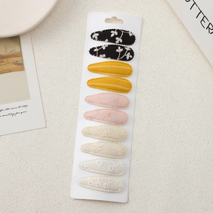 Detail showing 10-piece embroidered floral fabric snap hair clips for girls set