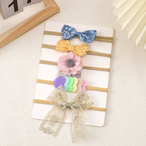 5-piece elastic baby headband set with lace bows and floral designs on display card