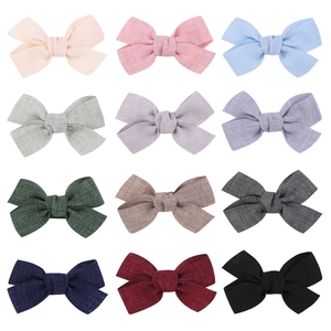 Set of 12 colorful cotton linen bow hair clips for infants and girls in a grid layout