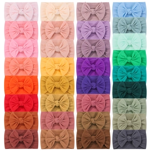 Set di 32 fasce elastiche in nylon per neonati in tinta unita con grandi fiocchi