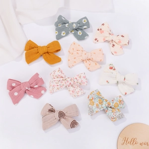 Set of 9 colorful cotton linen bow hair clips for kids with floral and solid patterns
