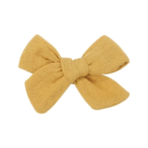 Detail of yellow cotton linen bow hair clip showing natural fabric texture and double layers