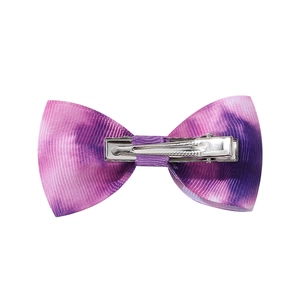 Détail du nœud papillon pour cheveux dégradé violet avec ruban texturé et pince en métal