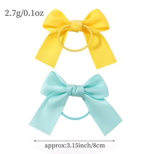 Two solid color bow hair ties in yellow and blue with weight and size specifications