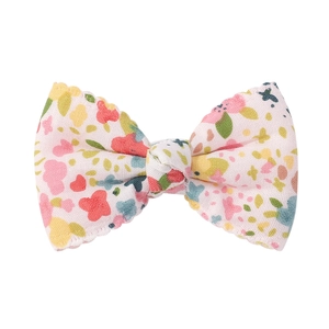 Detail of floral butterfly bow hair clip with jagged edges for girls and kids