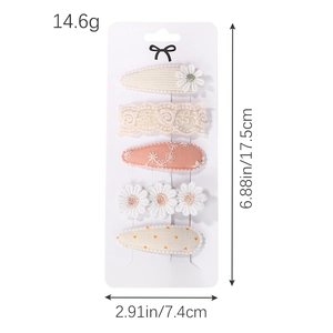 Set of 5 cute baby hair clips with floral embroidery and lace on a white display card