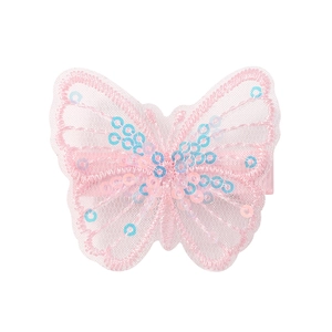 Detailed view of a pink mesh butterfly hair clip with delicate sequins and embroidery