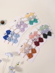 Close-up of baby headband set featuring diverse colors and floral printed bow patterns