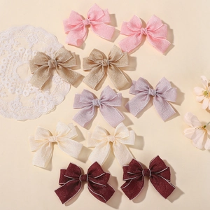 Five pairs of elegant fabric bow hair clips in pastel colors with white stitched edges