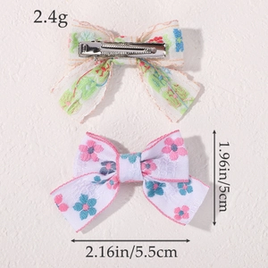 Floral fabric bow hair clips set for girls featuring pink flower patterns and metal clips