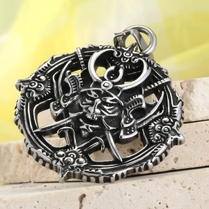 Vintage stainless steel samurai skull pendant displayed on stone texture background
