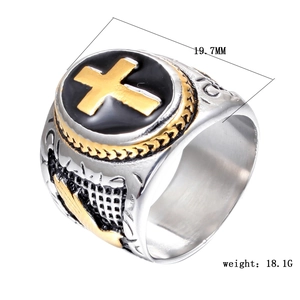 Detail of retro punk signet ring with golden cross and feather carving patterns