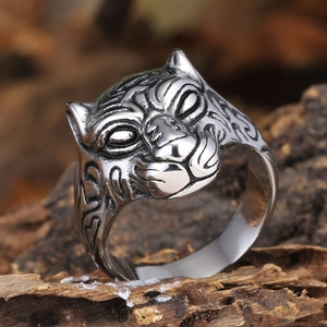 Macro detail of retro leopard head ring in stainless steel with vintage oxidized finish
