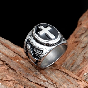 Macro view of vintage stainless steel cross ring with black enamel oval top and gothic texture