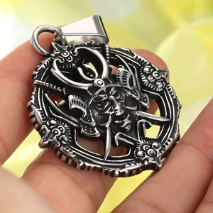 Macro shot of retro gothic stainless steel skull pendant with devil horns detail