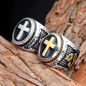 Vintage punk cross rings for men in silver and gold steel finish on bark background