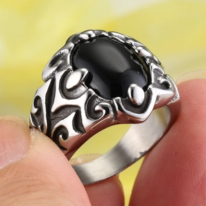 Detailed macro view of vintage stainless steel men's ring with black oval stone
