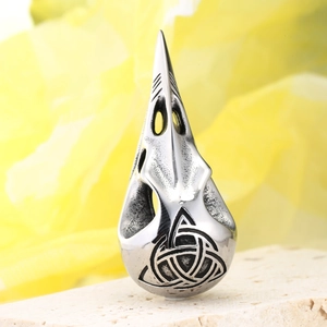 Detailed macro shot of vintage silver viking raven skull pendant with celtic triquetra knot