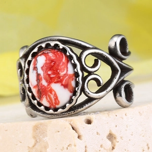 Détail macro de bague ethnique avec pierre en résine marbrée et anneau argenté gravé
