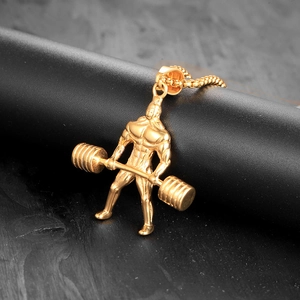 Pendentif doré de musculation montrant un athlète musclé avec une barre d'haltérophilie