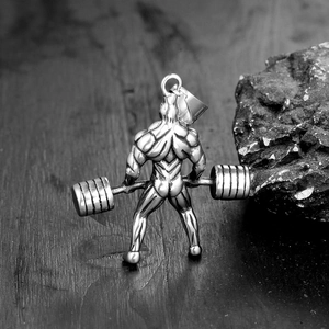 Détail macro du pendentif haltérophile musclé avec texture acier argent antique