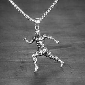 Detailed view of a silver muscular man pendant with a vintage finish and box chain