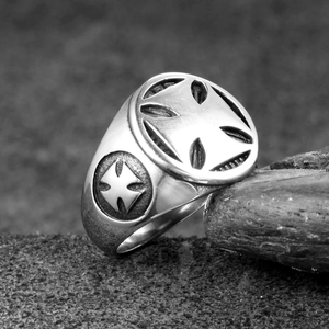 Detailed macro of vintage stainless steel ring with embossed Maltese cross pattern