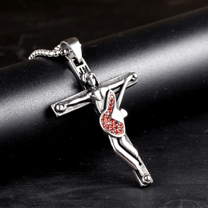 Detail of vintage silver gothic guitar cross pendant with red stones and JH engraving