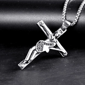 Macro shot of silver cross pendant featuring black zircon inlay on a box chain necklace