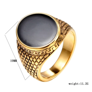 Detail view of gold vintage ring with black onyx, greek key pattern and 19mm width label