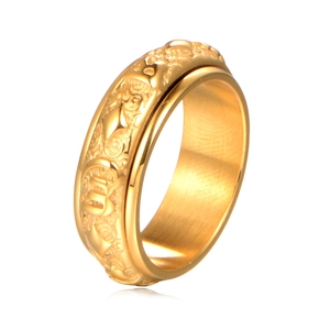 Golden stainless steel spinner ring with engraved Six-Word Mantra symbols on white surface