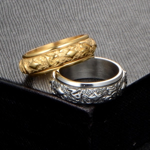 Rotating stainless steel spinner ring with engraved Buddhist mantra patterns