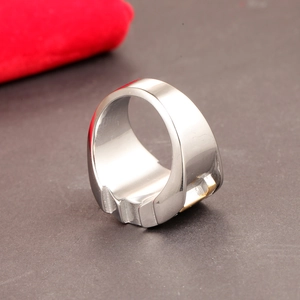 Macro detail of bicolored stainless steel ring featuring golden accents and jagged bottom
