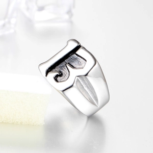 Mens stainless steel signet ring featuring geometric industrial pattern and silver finish