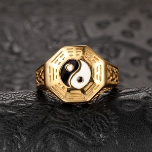 Macro shot of golden Taoist Bagua ring with Tai Chi Yin Yang symbol and vintage carvings