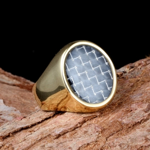 Polished gold signet ring for men featuring an oval carbon fiber inlay on natural bark