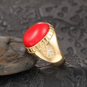 Bague vintage dorée en titane avec une grande pierre ovale rouge et détail d'étoile