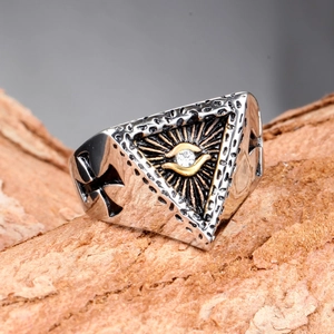 Detalle macro de anillo gótico de acero con ojo de diamante y grabado de cruz