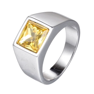 Men's wide stainless steel signet ring with a large square yellow gemstone on white background